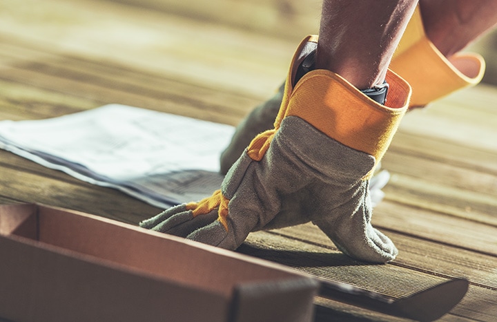Hands of construction on wooden boards.